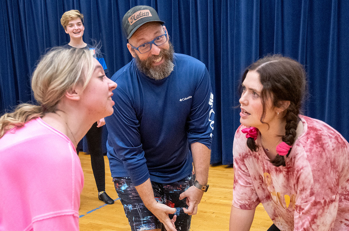 two young women and man on theatre stage